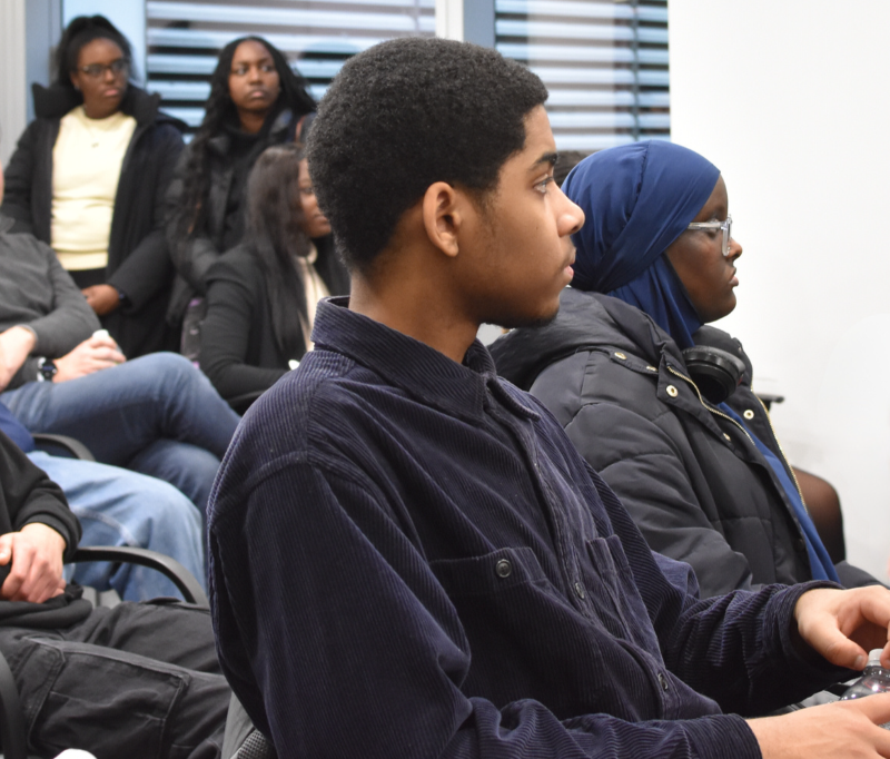 a seated group of male and female WIE mentees.