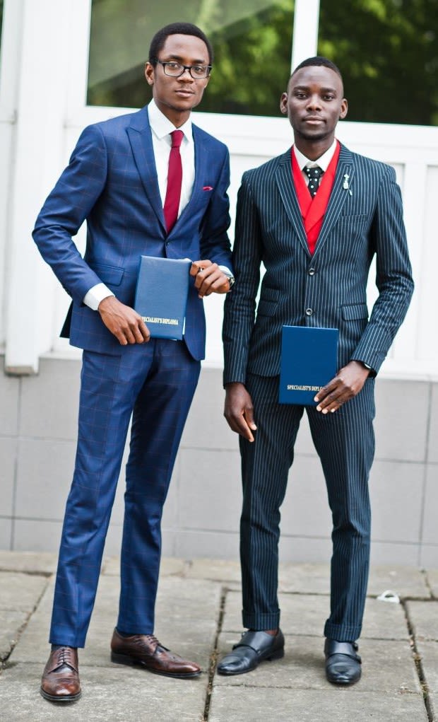 Two african american happy successful mans at suit with diploma at graduation day.