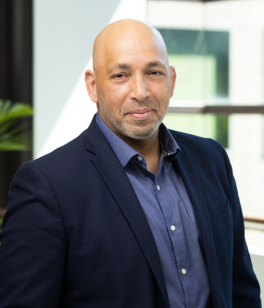 A headshot of Adam Mariano