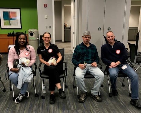 Risk employees sitting in the conference after donating blood.