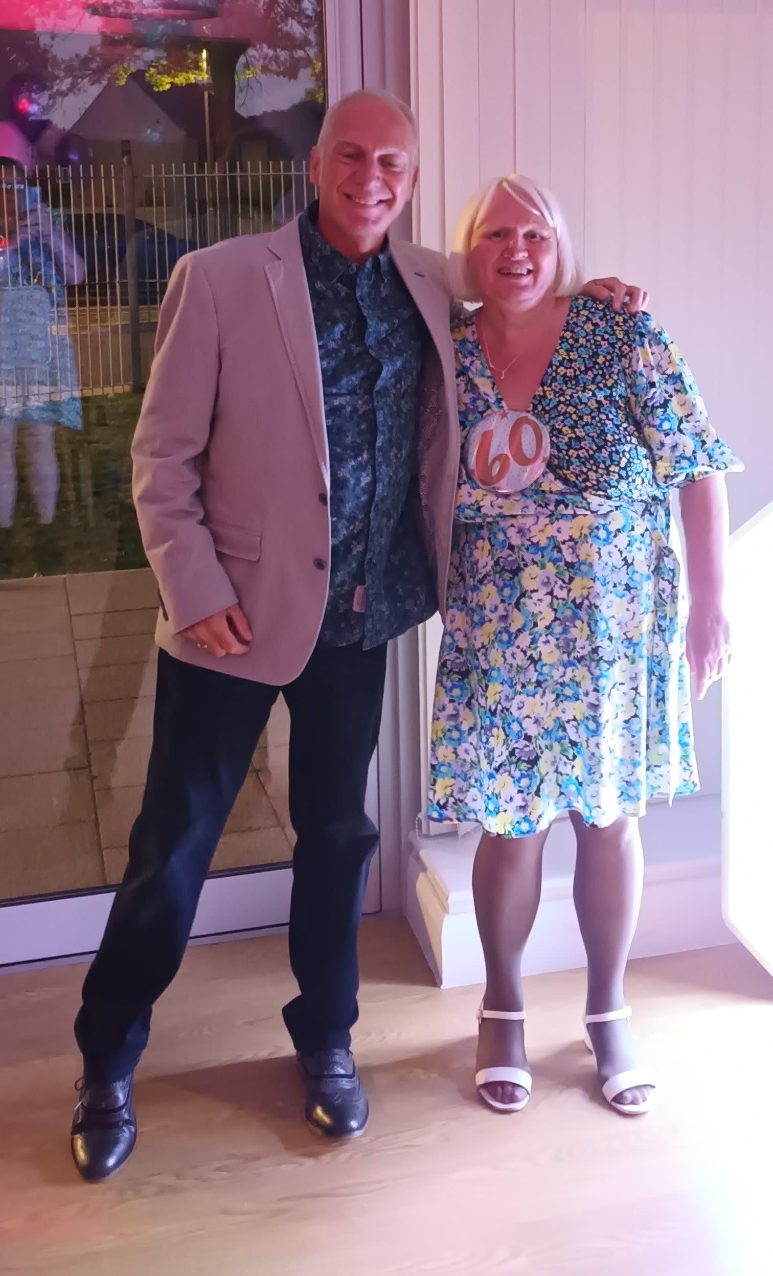 A photo of Mr. Mark Pickup and with Jackie, who at 60-years old successfully learned to read,at her 60th birthday party..